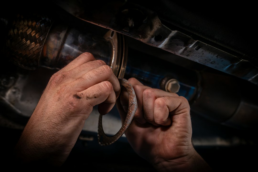A man working on a car's engine with a wrench